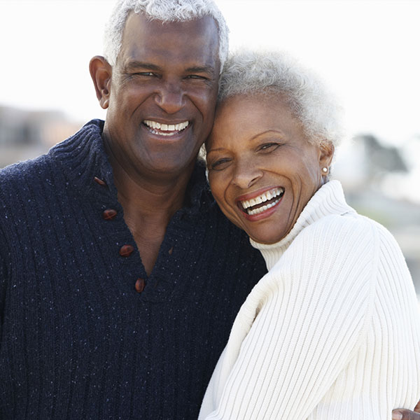 elderly couple smiling outside